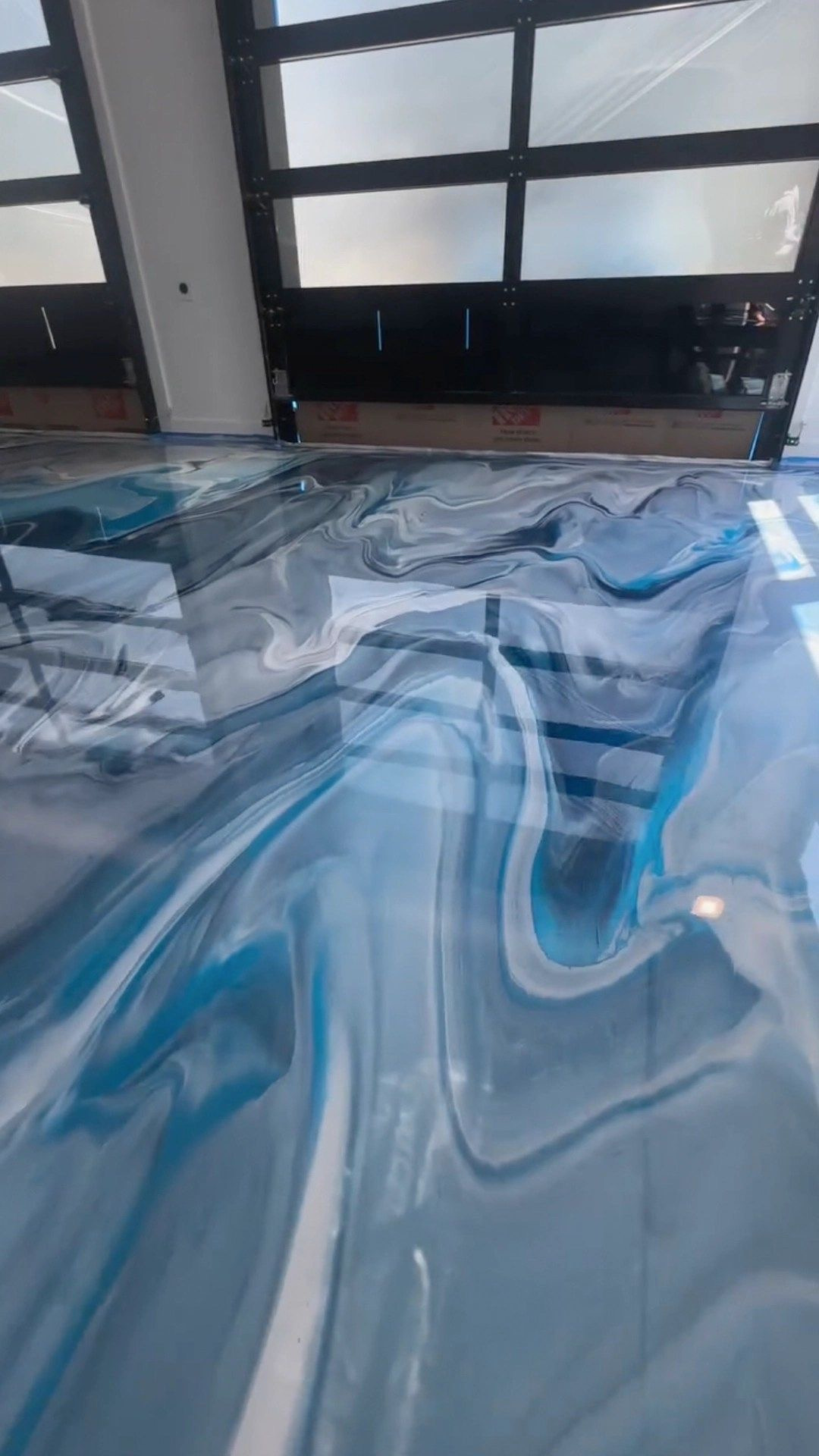 Blue and silver metallic garage floor with glass door