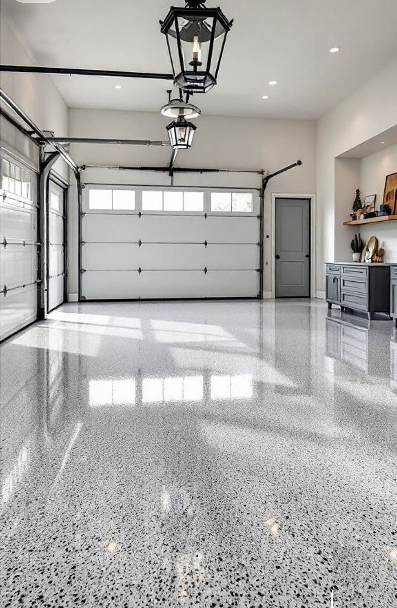 Gray and white flake epoxy garage floor with glossy finish
