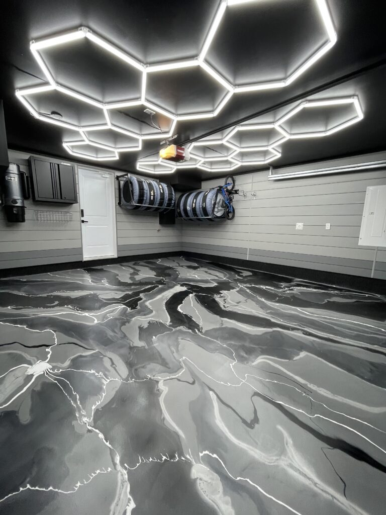 Black and silver metallic epoxy floor with hex lighting