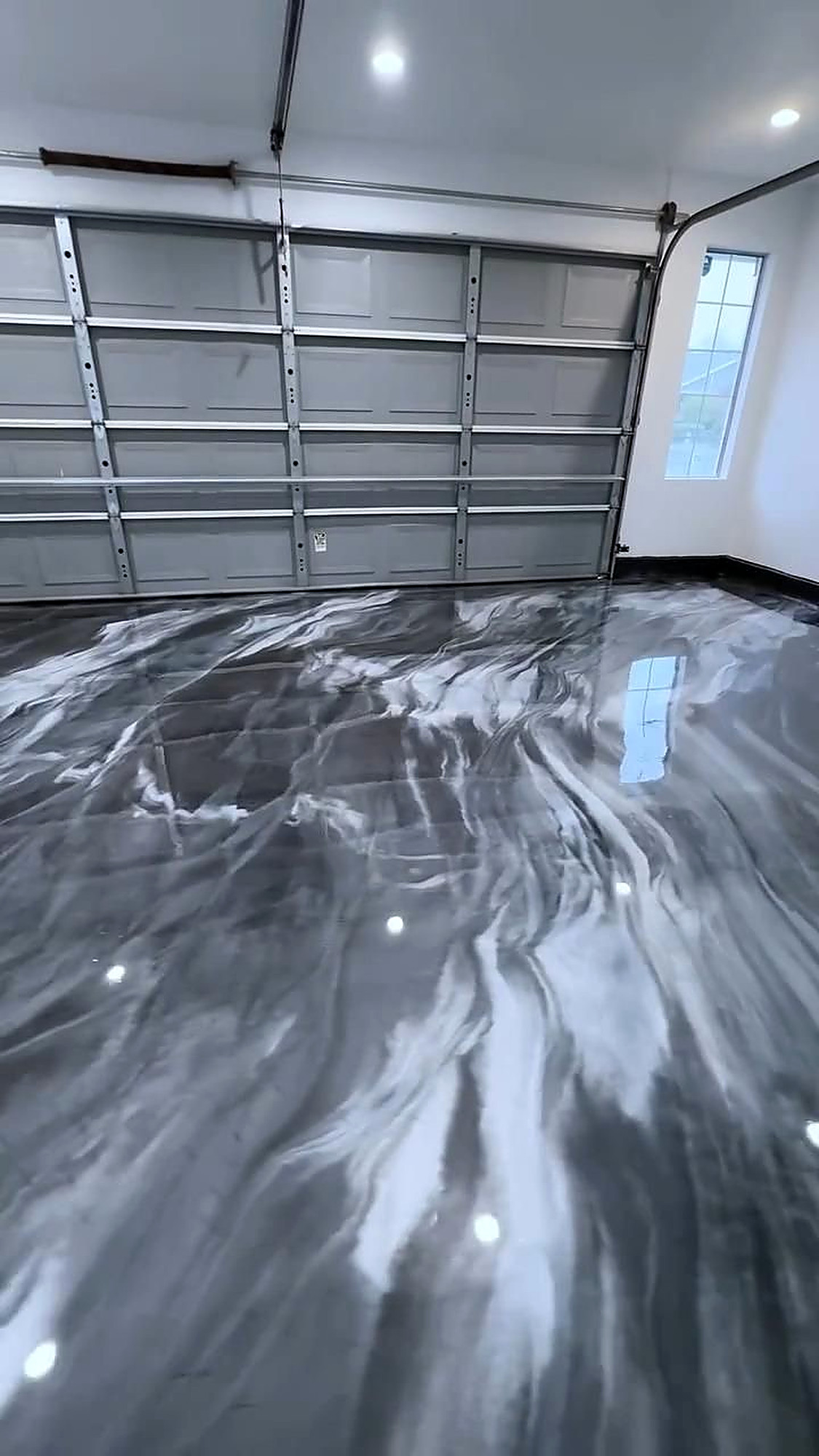 Gray and white metallic garage floor with car flags in Washington Utah